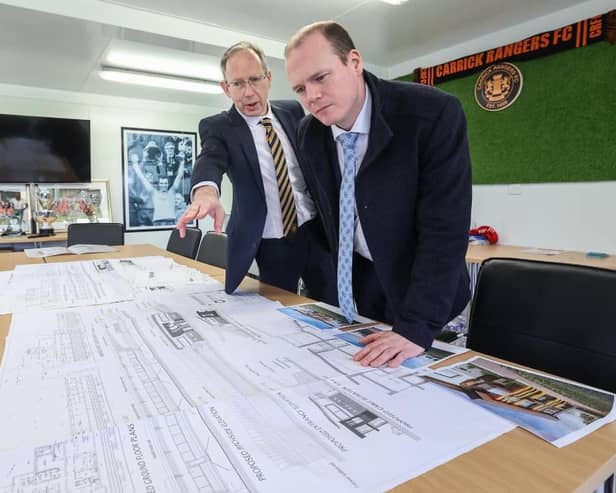 Communities Minister Gordon Lyons learning more about Carrick Rangers FC's development plans from chairman Peter Clarke. Photo: Department for Communities