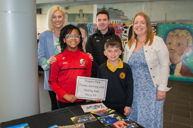 Looking at photos from past events at the Hart and Presentation Primary Schools Shared Education celebration are Mrs Lucy McEvoy, PPS teacher, Matiana Barbasa, PPS pupil, Caleb Dawson, Hart PS pupil, Paul Carvill, Healthy Kidz, and Catherine Davison, Hart PS teacher. PT18-237.