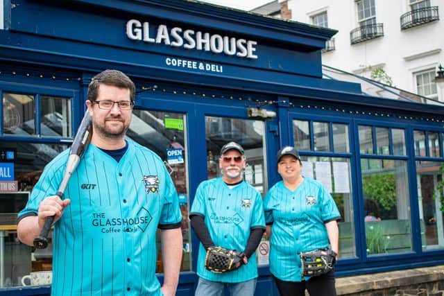 Glasshouse Coffee and Deli owner Martin Hutchinson with Lisburn Eagles softballers Paul Conlon and Michelle Sharkey.
