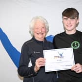Mary Peters Trust award winner and athletics competitor Zak Taggart from Coleraine is pictured receiving his award from Lady Mary Peters. Credit Mary Peters Trust