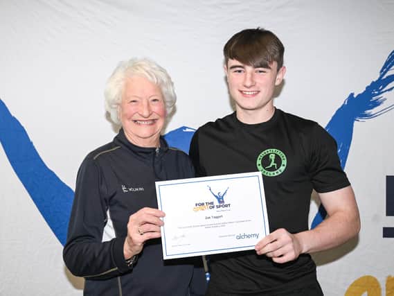 Mary Peters Trust award winner and athletics competitor Zak Taggart from Coleraine is pictured receiving his award from Lady Mary Peters. Credit Mary Peters Trust