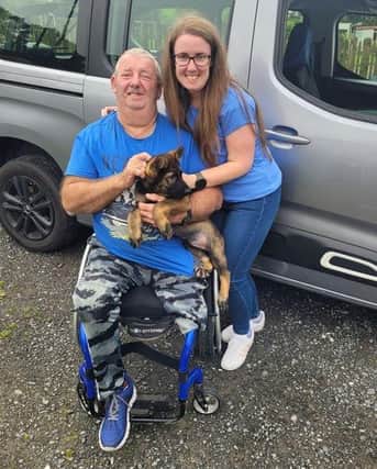Jimmy and Julie Thornton, with an adorable German shepherd pup recently rescued by 'Paws and People'.