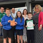 Newmills Primary School pupils Aaron Wilson, Dixie Patterson and Jacob Orlik collect their Eco-School of the Year award with Chair of Mid Ulster District Council, Dominic Molloy, Lisa Young, Rhondda Kelly and Peter McErlean