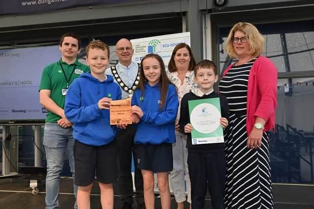 Newmills Primary School pupils Aaron Wilson, Dixie Patterson and Jacob Orlik collect their Eco-School of the Year award with Chair of Mid Ulster District Council, Dominic Molloy, Lisa Young, Rhondda Kelly and Peter McErlean