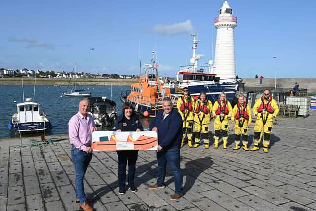 Prisoners at Maghaberry have used their gardening and baking skills to raise £4,500 for the Royal National Lifeboat Institution (RNLI). The money was collected through the sale of floral hanging baskets, planters and garden furniture made by prisoners in the prison gardens, and tray-bakes created in the prison kitchen and sold to staff. Maghaberry Prison Governor David Savage and Horticulture Officer James Carson present a cheque for £4,500 to Ann Couser from the Donaghadee RNLI Fundraising Team. Picture: Michael Cooper