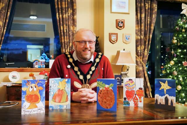 Mayor of Lisburn & Castlereagh City Council, Councillor Andrew Gowan with the winning card designs. Pic credit: LCCC