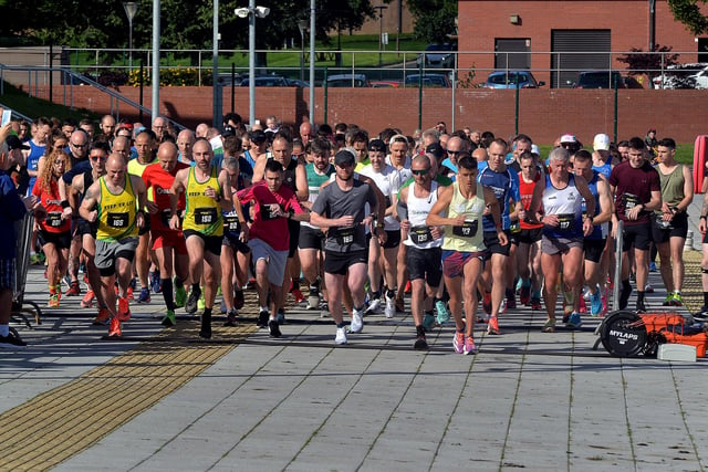 Runners hit the road at the start of the half marathon on Sunday. LM33-210.