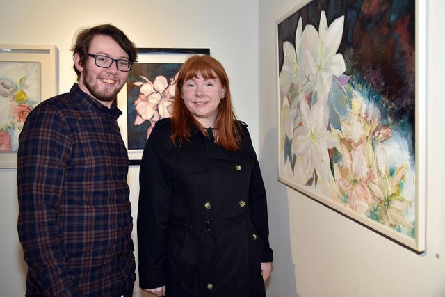 Darren Quinn and Fiona Murphy-McCormack admire some of the paintings on display at the exhibition. PT09-237.