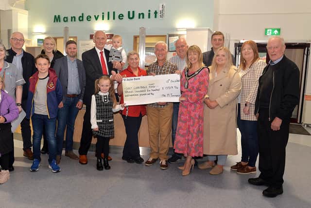 Michael Timmons and members of his family present a cheque to The Mandeville Unit at Craigavon Area Hospital. Also included is Lord Mayor of Armagh City, Banbridge, and Craigavon Borough Council Alderman Margaret Tinsley. Pic credit: Tony Hendron