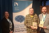 Alan Millar presents copies of the Scots Language Society anniversary anthologies to Pól Ó Frighil from Derry City and Strabane District Council’s Languages Team. Also pictured is Good Relations Officer Fiona Pegrum. CREDIT ALAN MILLAR