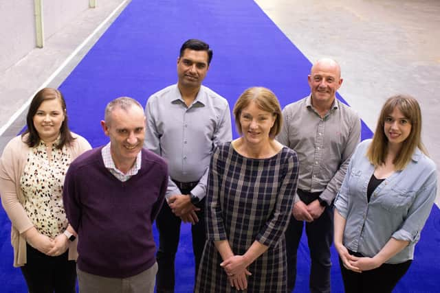 Pictured with the Royal Blue carpet for the Coronation of King Charles III are Nick Coburn, Group Managing Director, and Joyce McIvor, UK and Ireland Contract Sales Director, with representatives from different departments at Ulster Carpets (back row, from left) Hannah Topping, Manu Thomas, Andrew Carson, and Sarah Moffett.