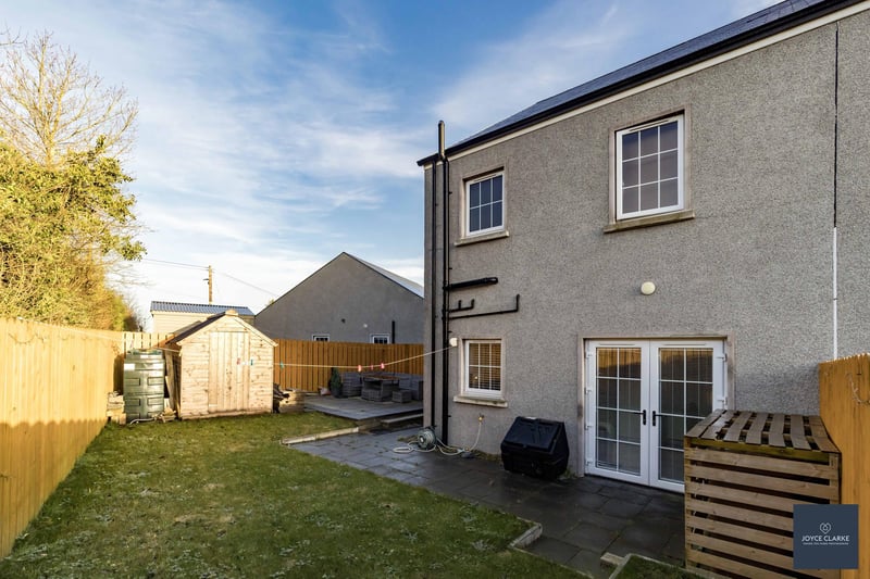 The fully enclosed south-west facing rear garden with gated access to the driveway. There is a paved patio area with additional raised paved patio area to the side of property. The garden laid in lawn and there is space for a shed, oil tank and burner
