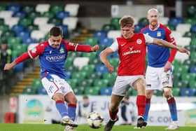 Linfield’s Jordan Stewart with Larne’s Dylan Sloan during Monday evening's match at Windsor Park. Picture: Jonathan Porter / Press Eye