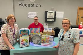 UNISON Trade Union Chair Gillian Foley (red shirt), Hospital Play Specialist’s Sharon Pauley and Gillian Sinclair receive the donation of sensory equipment. Pic credit: SEHSCT