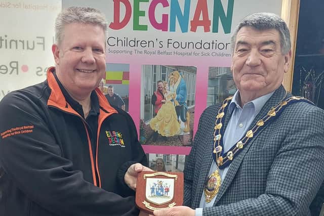 Gerald Degnan is presented with a plaque by the Mayor of Mid and East Antrim, Alderman Noel Williams, in recognition of his charity work.