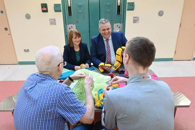 Governor of Maghaberry Prison, David Savage and Julie McConville, Assistant Director for Specialist Child Health and Disability with the Southern Health & Social Care Trust, review the crocheting work of the ‘Stitch in Time Gang’. Picture: Michael Cooper
