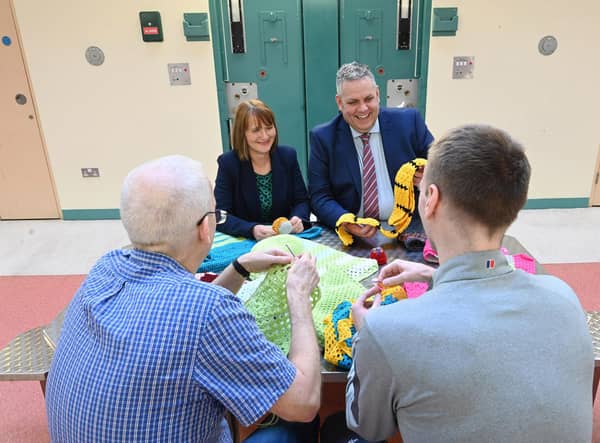Governor of Maghaberry Prison, David Savage and Julie McConville, Assistant Director for Specialist Child Health and Disability with the Southern Health & Social Care Trust, review the crocheting work of the ‘Stitch in Time Gang’. Picture: Michael Cooper
