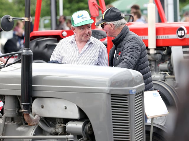 Old friends meet amongst the tractors at the Balmoral agricultural show.