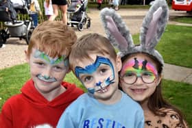 Showing off their painted faces at the Easter Trail and Fun Day are Logan Kerr (8), Freddie Kerr (3) and Lily Grace Brown (7). PT15-202.