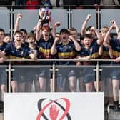 Bann U14 captain Ryan Johnston raises the Ulster Cup as the rest of his team celebrate their win at the Kingspan Stadium.