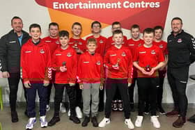 Players from the 2010 side alongside coaches Shane James and Julian McGrath.