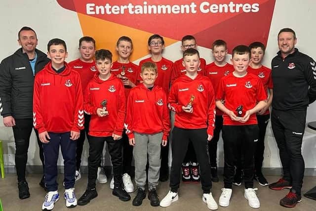 Players from the 2010 side alongside coaches Shane James and Julian McGrath.