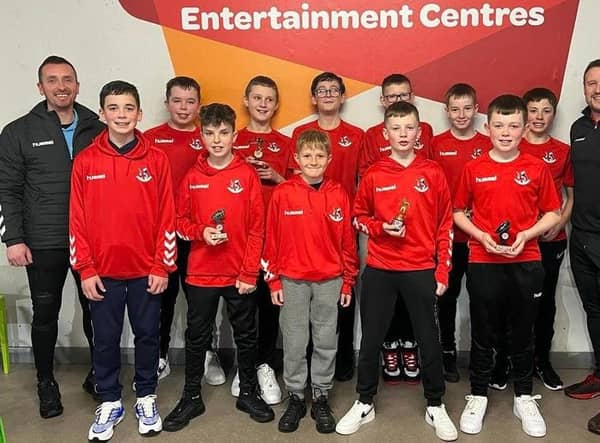Players from the 2010 side alongside coaches Shane James and Julian McGrath.