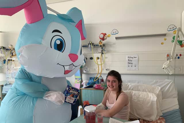 Courtney Reid receives a visit from the Easter bunny at the Ulster Hospital’s Paediatric Ward. Pic credit: SEHSCT