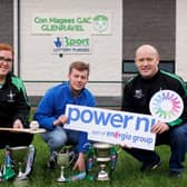 Pictured (L-R) with some of the trophies recently won by Glenravel GAC is Oonagh Ward, Power NI employee and club member, Oliver Howie of Power NI, and Brídíní Óga coach Martin Coulter.