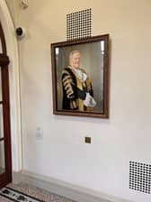 A vandalised portrait of former DUP mayor Lord Browne is back in its rightful place in Belfast City Hall after being vandalised. Photo: Belfast City Council