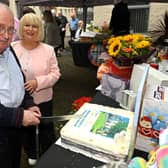 Jim Hamilton who lives at Brennen Court cuts the anniversary cake with Carol McTaggart, Chief Executive at Clanmil Housing