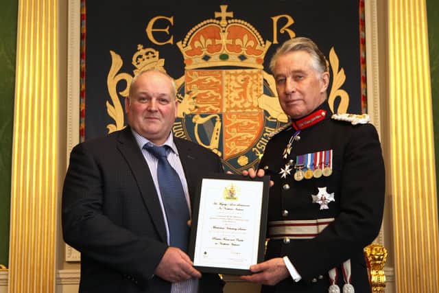 Corporal McElroy is pictured in the august setting of The Throne Room at Hillsborough Castle receiving certificate and congratulations from The Earl of Caledon, His Majesty’s Lord Lieutenant for the County of Armagh.