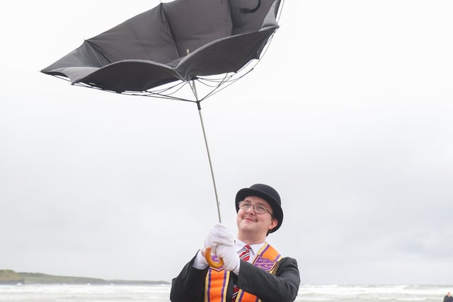 Brother Samuel Douglas, District Lay Chaplain from the Loughbrickland District has some trouble with his umbrella on the beach.