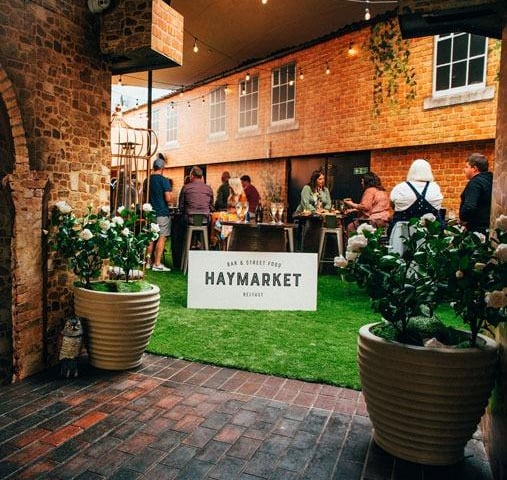 At the top of Royal Avenue, the outdoor portion of this venue has become one of the hottest places for an alfresco drink or dinner.
From pizzas to loaded fries and nachos, be sure to check out what all the fuss is about! The former Hudson bar creates a laid back atmosphere with carefully subtle local references to create a truly appealing atmosphere.
Following a £250,000 investment intended to kickstart the revival of the Union Quarter, the first floor also houses a dedicated gin bar, with up to 40 choices, while a wide-ranging drinks menu offers both classic cocktails and local beer and ale.
For more information go to haymarketbelfast.com