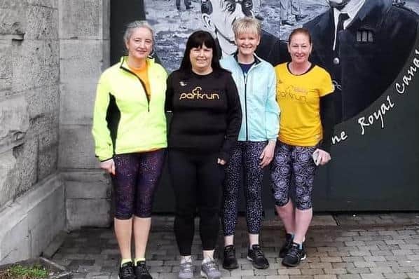 Catherine Byers celebrating her 250th parkrun at Progression parkrun with fellow members