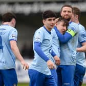 Warrenpoint Captain Jim O'Hanlon congratulates Michael Leddy after his second goal on Saturday. BM11