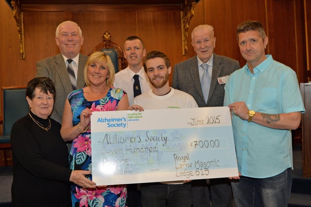 Andy Boal (centre), community fundraiser, with the East Antrim branch of the Alzheimer's Society, pictured in 2015 accepting a cheque for £700 from Alan McKeown, WM of Royal Larne Masonic Lodge 615 and wife Adele, along with Lillian Geary and Ted Geary and Scott Hutchinson from Royal Larne Lodge 615 and Hugh Giffen from St Patrick's Union Lodge 175. The money was raised at an 80s disco night which Alan organised and held in Larne Masonic Centre. INLT 23-009-PSB