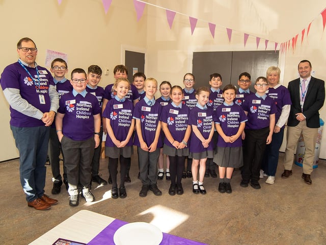 P6 and P7 pupils at Richmount Primary School who organised the coffee morning in aid of the NI Children's Hospice. Also included are adults from left, Simon Clyde, teacher, Diane Clarke classroom assistant and Neil Johnston, school principal.