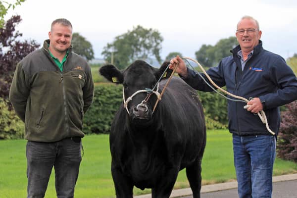 Stuart Hawthorne from Kinallen was the winner of the pedigree Aberdeen Angus heifer Coltrim Evana X747. He received his prize from Ivan Forsythe, Moneymore. Credit: Julie Hazelton