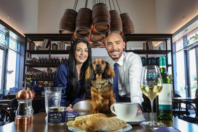Managers of the Hinch Cafe, Harriet Finnigan and Darren Cosgrove, are pictured with puppy, Lola. Pic credit: Hinch Cafe,