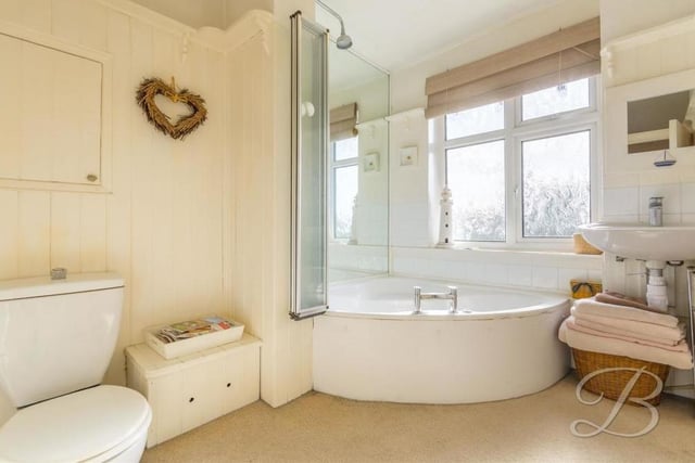 Sandwiched between two bedrooms at the back of the property is this stylish family bathroom. It boasts a corner bath with shower above, low-flush WC, wash hand basin and a window.