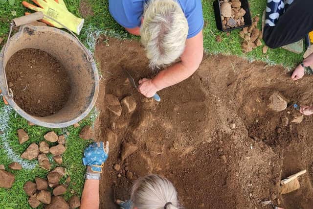 Volunteers trowelling the upper levels of soil away in 2023 Kilmocholmóg dig. Picture: Craigavon Historical Society