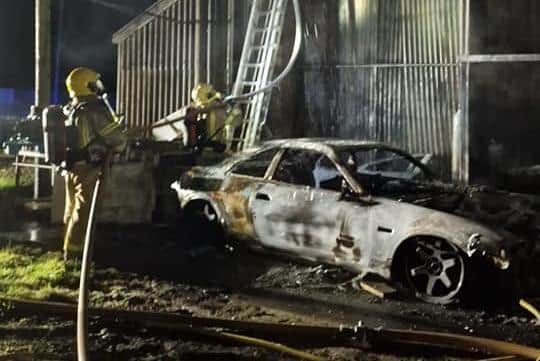 Firefighters work to extinguish blaze as cars and sheds destroyed in the Scotch Street area of Portadown last night.