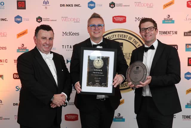 Bill Penton, managing editor of the Licenced Catering News presents the award for Pub of the year to Trevor McCann of The Corner House Bar, Derrymacash. Also pictured is JC Rice of Tennents NI who sponsored the award. Picture: Phil Smyth Photography.