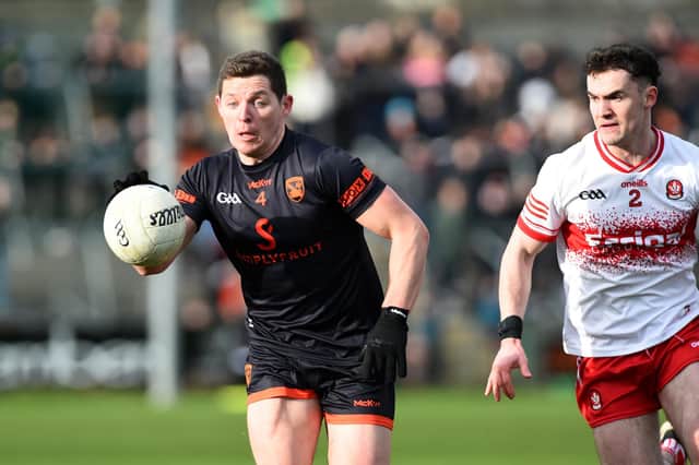 Armagh's Paddy Burns sprints past Derry's Diarmuid Baker during their league meeting in March.