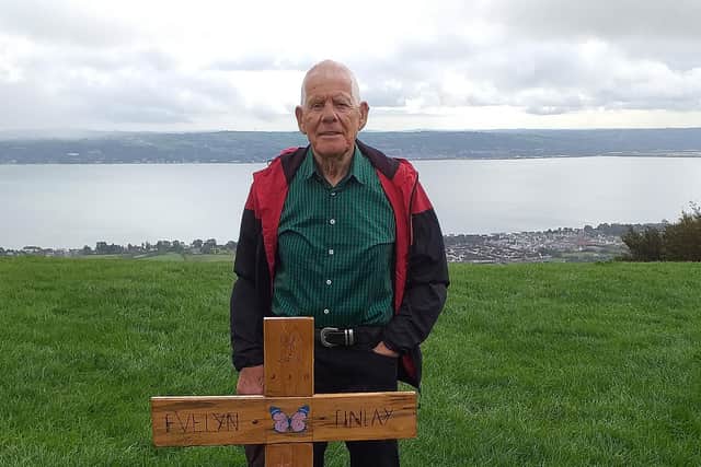 Mr Finlay with one of the memorial crosses at Knockagh Monument.