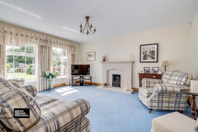 Lounge with gas fire in a sandstone fireplace, with matching hearth and surround.