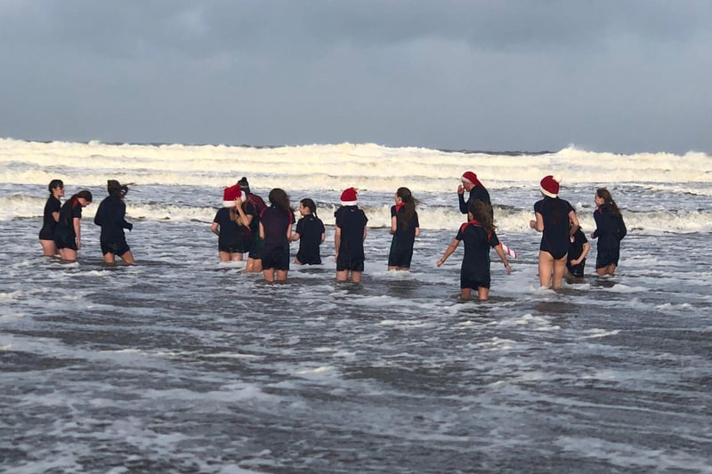 Pictured during their sea dip debut on Portstewart Strand are the brave Year 8 pupils from Coleraine Grammar School; Amber Miller, Anna McGreevy, Elise Archibald, Erin Semple, Eva Grace Patterson, Isabella McCarron, Jasmine Moore, Jessica Cartmill, Josie Dixon, Lucy Blackstock, Poppy Ewing, Sarah McCaughey and Tilly Lyttle. Also in the sea are Mr Semple and Mr Cartmill