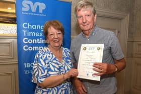St Vincent de Paul member Peter Kearns is presented with a certificate by Mary Waide, SVP Regional President for the Northern Region, recognising his 50 years of volunteering for SVP in the Armagh and Craigavon area.