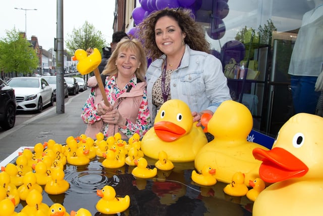 Out for a duck...Customer Bernie O'Hare, left, tries her luck at catching a discount prize at the opening of the new Menarys store, Lurgan. LM18-211.